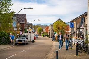 Diepenheim, Netherlands - April 7, 2024. People sitting at the cafe and restaurants, walking on the street of village Diepenheim on the north west coast of Holland. High quality photo