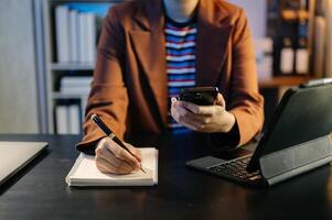 business hands working with digital tablet computer and smart phone with financial business strategy layer effect on desk photo