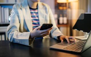 Confident businessman working on laptop,tablet and smartphone at her workplace at office. photo