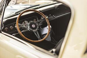 Vicenza Italy 19 March 2024 Detail shot of the vintage Shelby Mustang s dashboard and steering wheel showcasing luxury and control photo