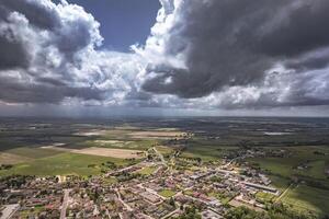 Aerial View of Stormy Clouds Over a Northern Italian Village photo