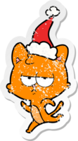 bored hand drawn distressed sticker cartoon of a cat wearing santa hat png