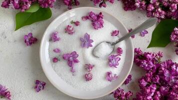 Bowl of Sugar With Lilac Blossoms on a Textured Background video