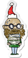 hand drawn distressed sticker cartoon of a worried man with beard and stack of books wearing santa hat png