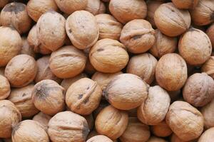 stack of natural walnuts selling at shop photo