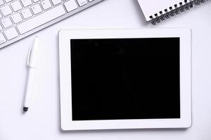 Top view of digital table with empty screen on white background photo