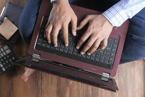 work from home concept, Top view of man using calculator. photo