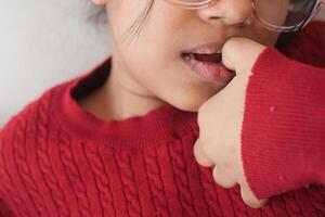 child girl biting her nails at home, photo