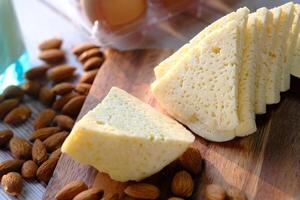 Close up of cheese and almond nut on table. photo