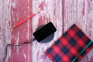 charging Smartphone Using Wireless Charging Pad, top view photo