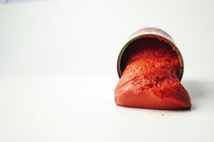 Tomato paste in a preserved container on white background photo