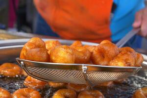 Traditional fried sweets lokma in sugar syrup photo