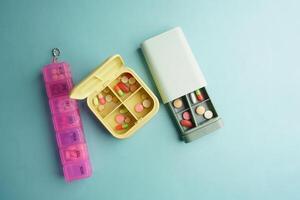 top view of medical pills in a pill box on table photo