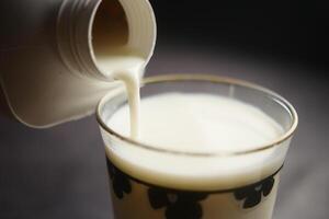 slow motion of pouring milk from a container close up photo