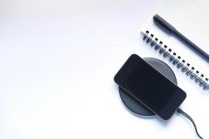 charging Smartphone Using Wireless Charging Pad, photo