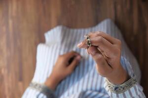 muslim man keep hand in praying gestures during ramadan, Close up photo