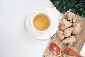 Ginger tea with ginger on table , high angle view . photo