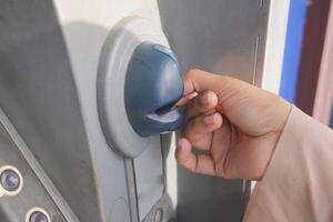 Hand Using Credit Card To Withdrawing Money From Atm Machine. photo