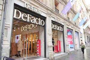 Turkey istanbul 18 july 2023., Defacto store front featuring a metal sign in a modern font on a glass facade at taqsim square photo