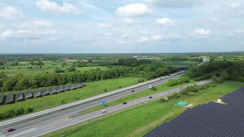 Drone view of a highway in Germany with a lot of traffic and many green fields around it. video