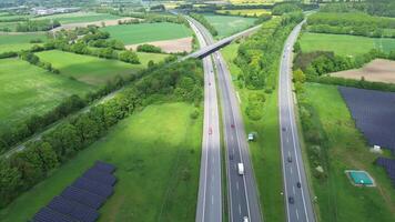 Drone view of a highway in Germany with a lot of traffic and many green fields around it. video