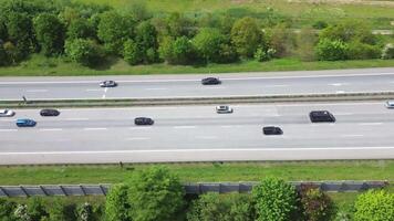 Drone view of a highway in Germany with a lot of traffic and many green fields around it. video