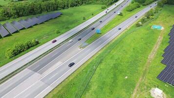 Drone view of a highway in Germany with a lot of traffic and many green fields around it. video