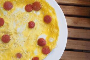 Egg Omelette with sausage on table photo