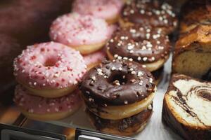 chocolate donuts display for sale at local store photo