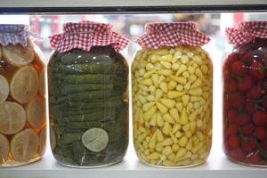Canned fruits and vegetables in glass jars photo