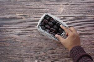 top view of hand pick date fruit on table photo