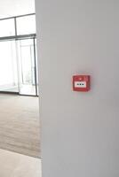 Red fire alarm button on wall , photo