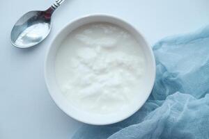 Close up of greek yogurt in a bowl on table photo