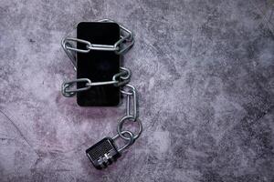 Smart Phone With Padlock And Chain Over White Background. photo