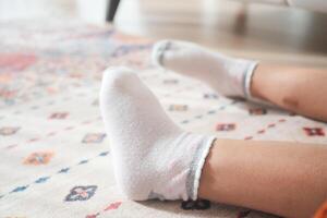 a white soft socks on child feet . photo