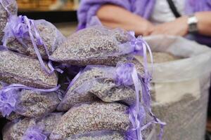 A stack of purple lavender bags fills the basket, creating a beautiful pattern photo