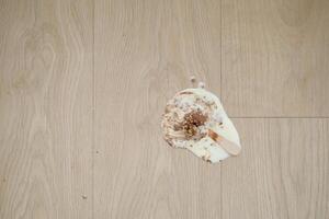 ice cream melting and spilling on floor , photo