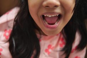 close up of child screaming at home photo