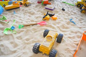 sand and colorful toys in a playground indoors. photo