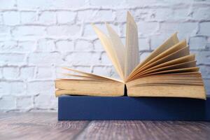 open book on table against a wall. photo