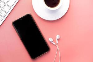 smart phone and earphone on pink background . photo