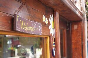 welcome text hanging on cafe door photo