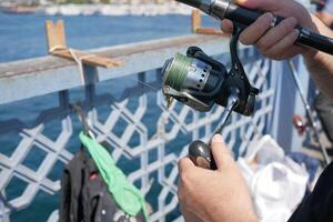 Fisherman with rod, spinning reel , photo