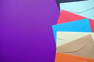 high angle view of colorful envelopes purple background photo