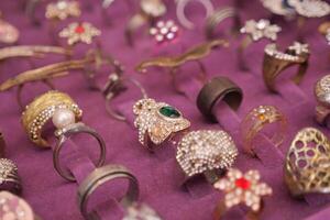 Various rings showcased on a blue petal, like jewelled headgear photo