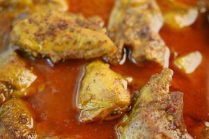 Chicken curry or masala in a bowl on table photo