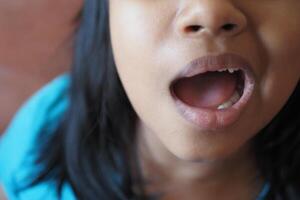 close up of child screaming at home photo