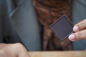 woman holding a dark chocolate candy photo