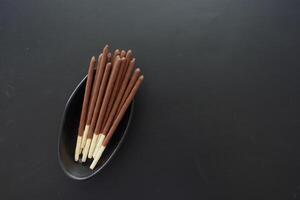 almond nut dark chocolate stick on table photo