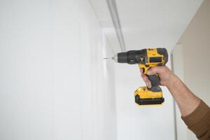 slow motion of using electric drilling on white wooden board photo